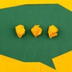 a word bubble made of yellow pieces of paper