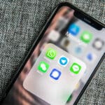 A phone with messaging apps open on the screen